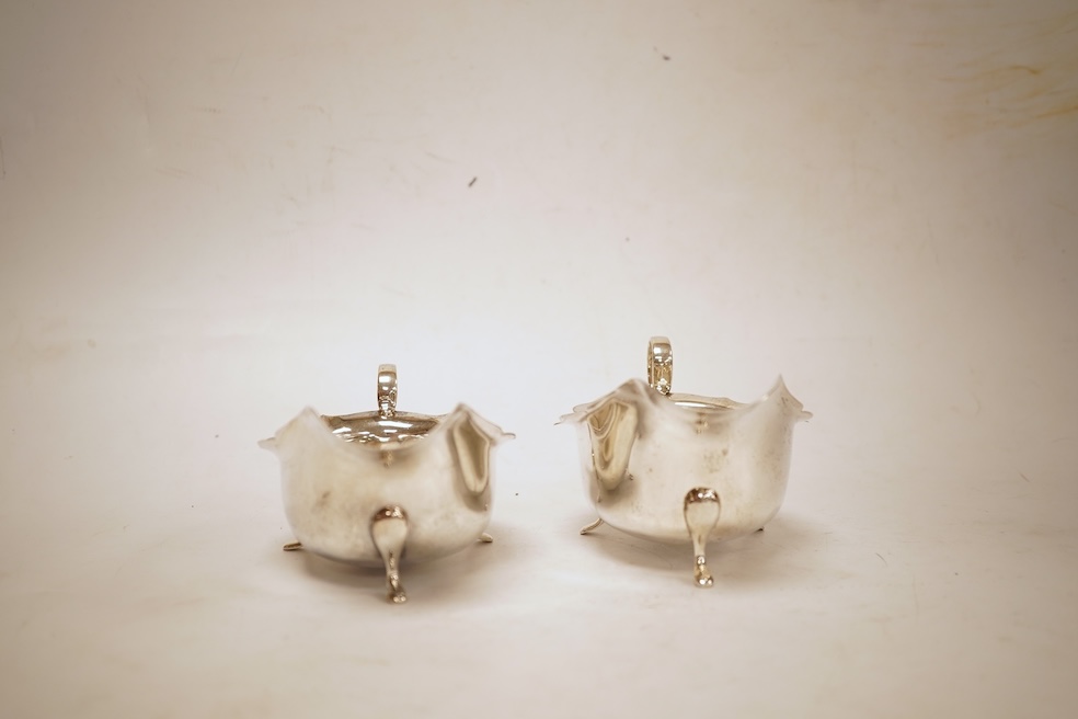 A pair of 1930's silver sauceboats, with cut borders, Barker Brothers Silver Ltd, Birmingham, 1935 and 1938, length 14.6cm, 5.8oz.